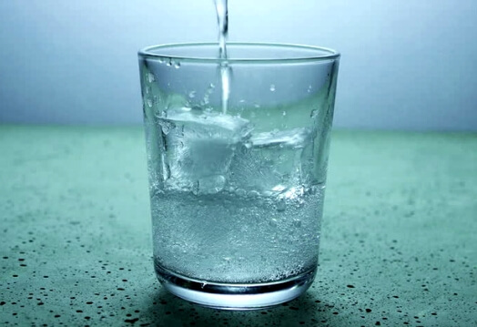  A clear glass is being filled with clean water, showcasing Allegiance Water's water treatment.<br />

